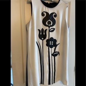 White dress with black faux-leather flowery detail